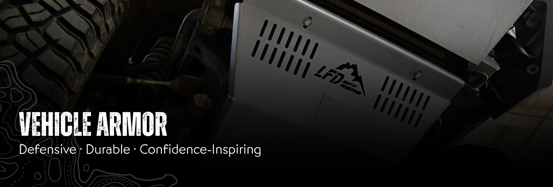 Close-up of LFD skid plate mounted on the underside of a vehicle, with text "Vehicle Armor - defensive, durable, confidence-inspiring"