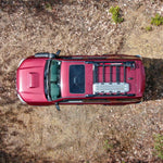 Top view of a red 5th Gen 4Runner with installed crossbars on the roof for carrying cargo.