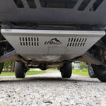 A front skid plate on a 5th Gen 4Runner, constructed of metal and featuring a Welded backing plate with countersunk holes for bolts, positioned under the vehicle's front bumper.
