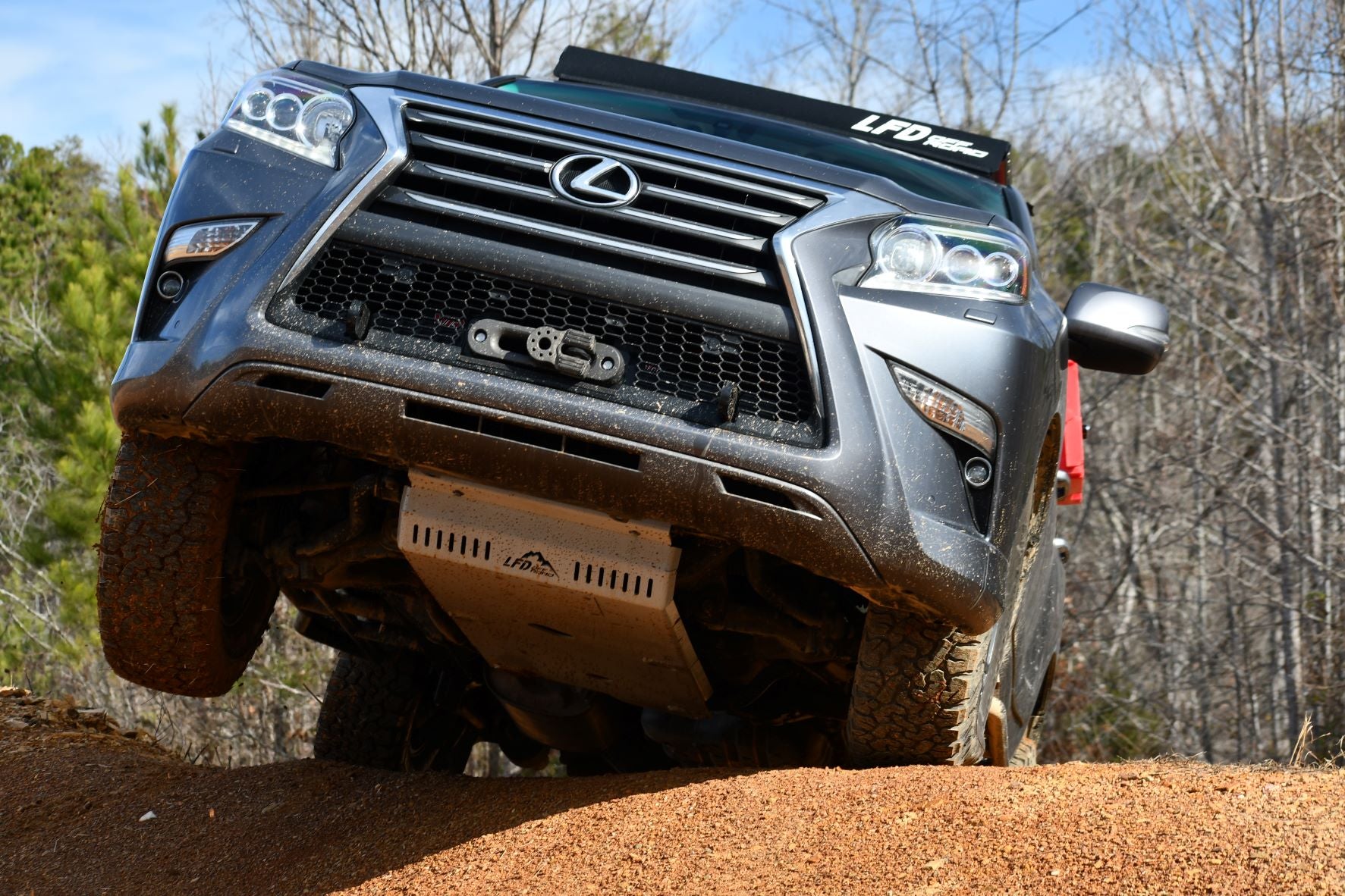A front skid plate designed for a GX460 vehicle, depicted in a raw metal finish, mounted on the front bumper area.