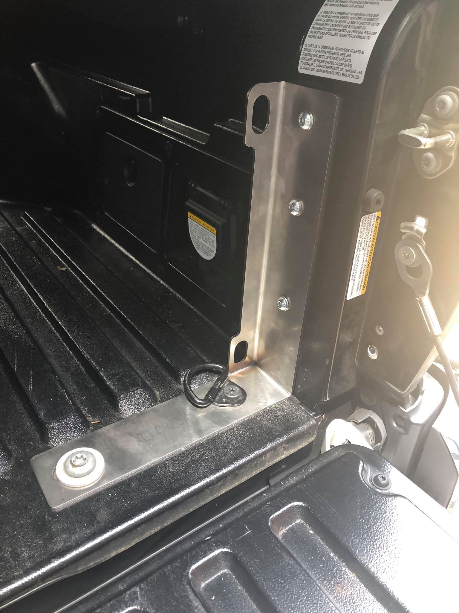Stainless steel bed stiffeners installed on the bed of a pickup truck, designed to reinforce the bed for additional weight.