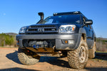 A black hybrid front bumper designed for a 4th gen 4Runner, showing the bumper's mounting points and recovery points in relation to the vehicle's frame.